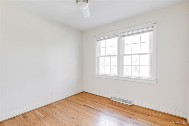 spare room featuring ceiling fan and light hardwood / wood-style flooring