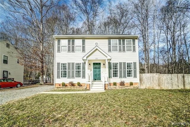 colonial-style house with a front yard