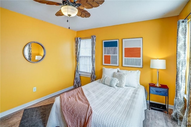 bedroom with wood-type flooring and ceiling fan