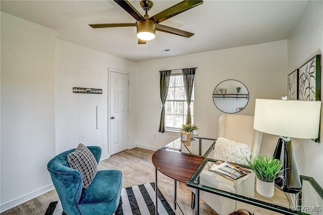 sitting room featuring light hardwood / wood-style flooring and ceiling fan