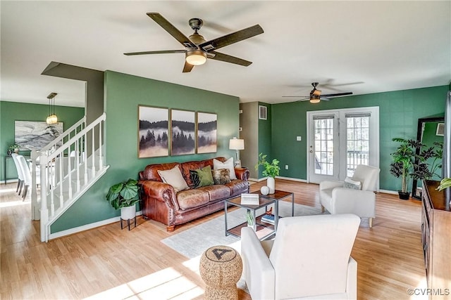 living room featuring ceiling fan and light hardwood / wood-style floors