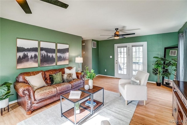 living room with ceiling fan and light hardwood / wood-style floors