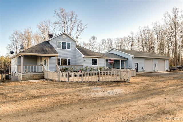 view of front of property featuring a porch, a garage, and central AC unit