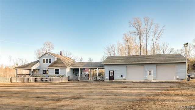 back of property with a garage, a lawn, and covered porch