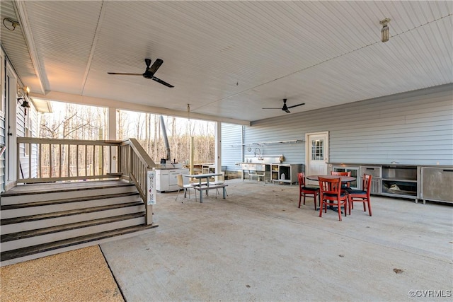 view of patio / terrace with ceiling fan and exterior kitchen