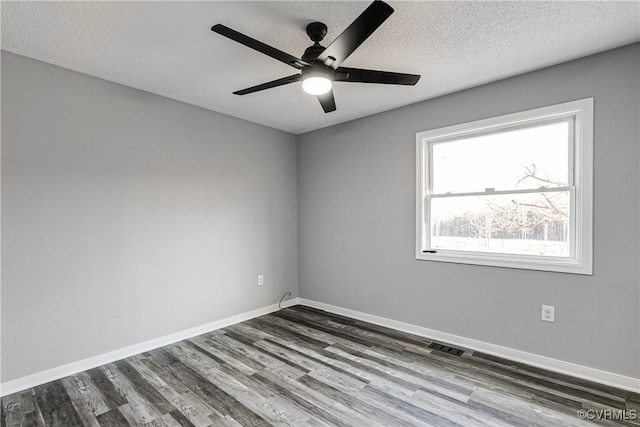 unfurnished room with ceiling fan, dark hardwood / wood-style floors, and a textured ceiling