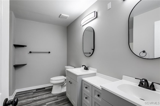 bathroom featuring vanity, hardwood / wood-style floors, and toilet