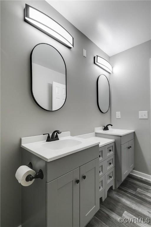 bathroom with vanity and wood-type flooring