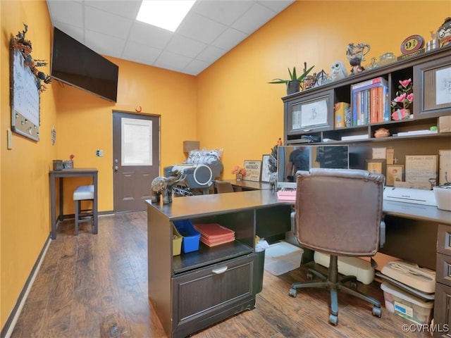 office area featuring a paneled ceiling and dark hardwood / wood-style flooring