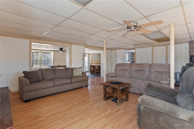 living room with a drop ceiling, ceiling fan, and light hardwood / wood-style flooring