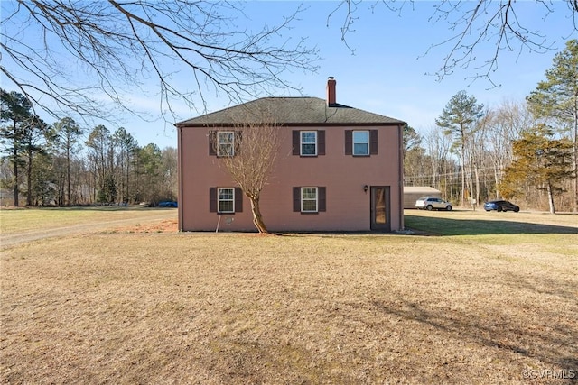 view of side of property featuring a yard