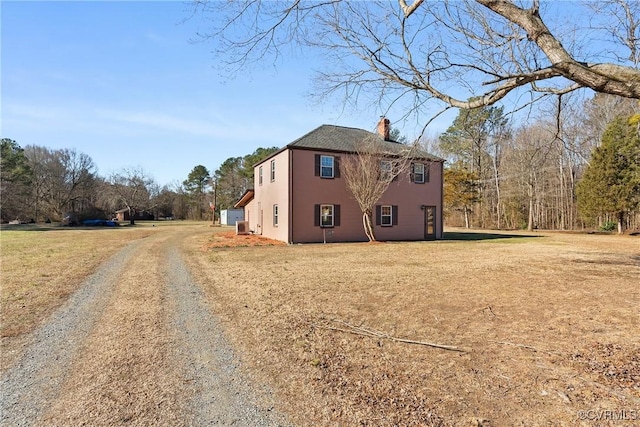 view of side of home with a yard