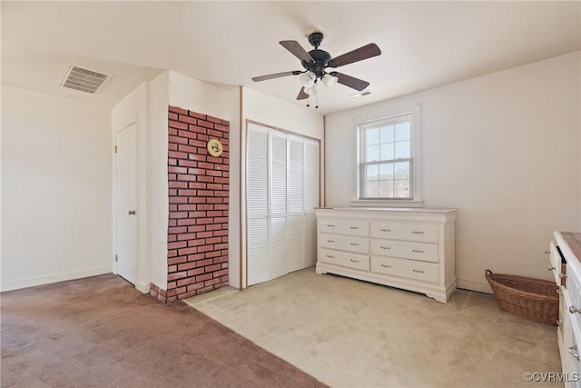 unfurnished bedroom featuring light carpet, ceiling fan, and a closet