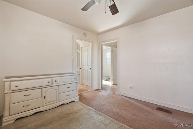 carpeted spare room with ceiling fan