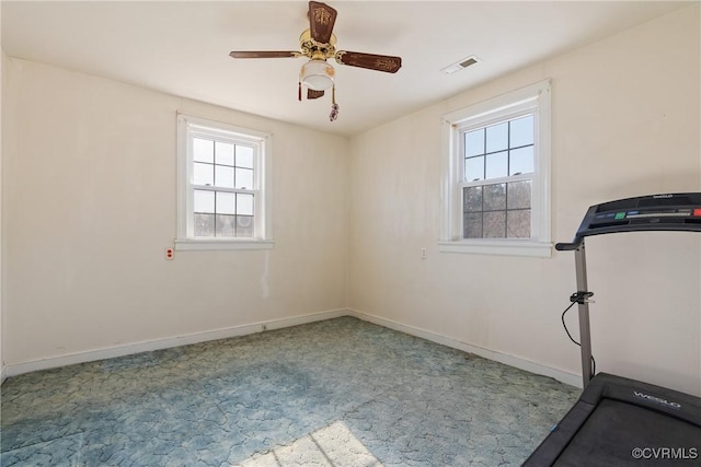 exercise room featuring ceiling fan and a healthy amount of sunlight