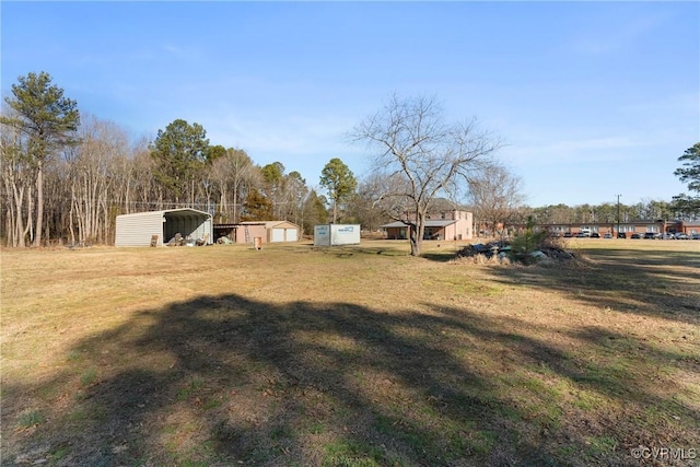 view of yard with a carport and a shed