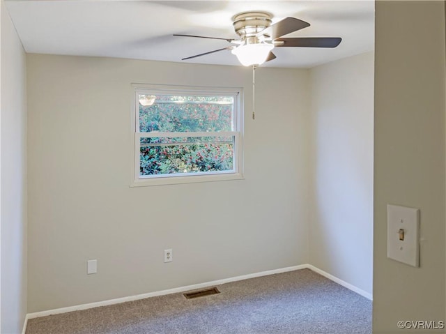 empty room featuring carpet floors and ceiling fan