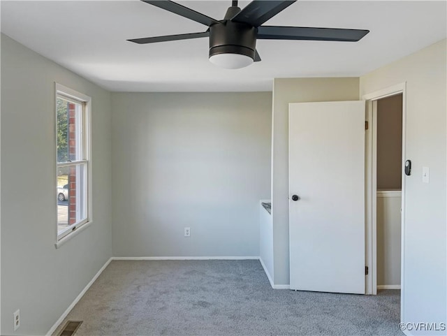 spare room featuring carpet floors and ceiling fan