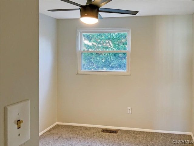 carpeted spare room with ceiling fan