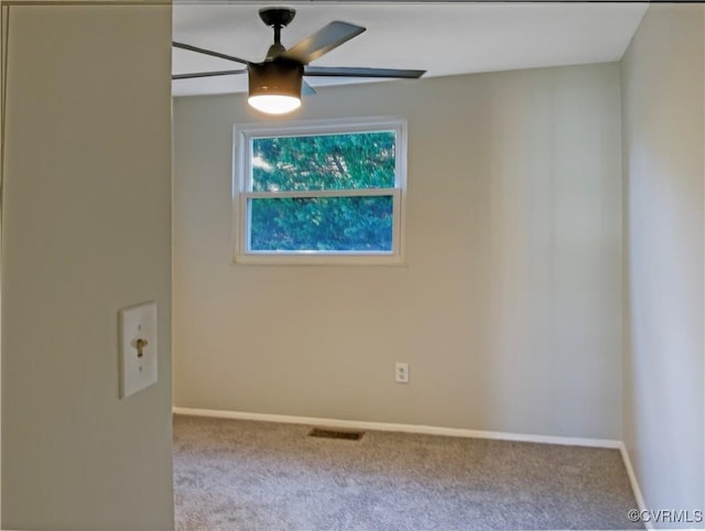 carpeted spare room featuring ceiling fan