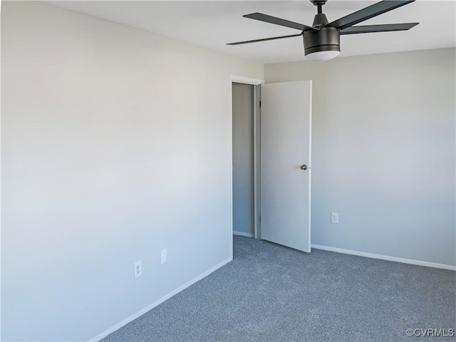 carpeted spare room featuring ceiling fan