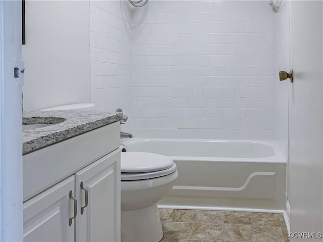 full bathroom with vanity, toilet, and tiled shower / bath combo