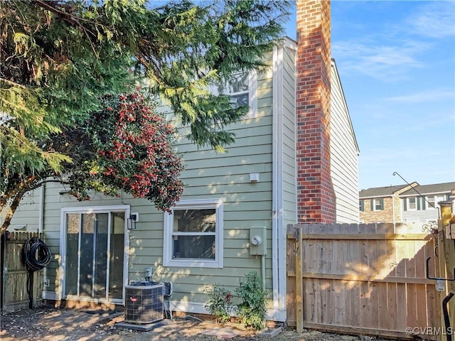 back of property featuring central AC unit