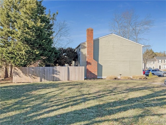 view of side of home featuring a lawn