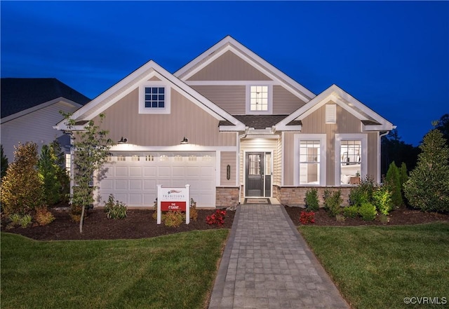 craftsman-style home with a garage and a front lawn