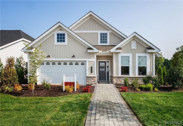 craftsman inspired home with a garage and a front yard