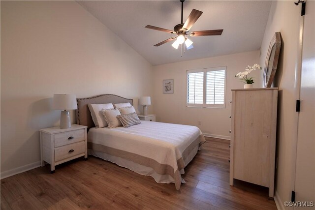 bedroom with lofted ceiling, dark wood-type flooring, and ceiling fan