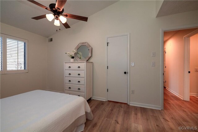 bedroom featuring ceiling fan, vaulted ceiling, and light hardwood / wood-style flooring