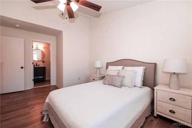 bedroom featuring dark hardwood / wood-style flooring, ensuite bath, and ceiling fan