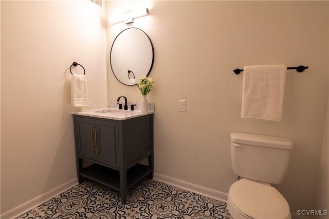 bathroom featuring tile patterned floors, toilet, and vanity