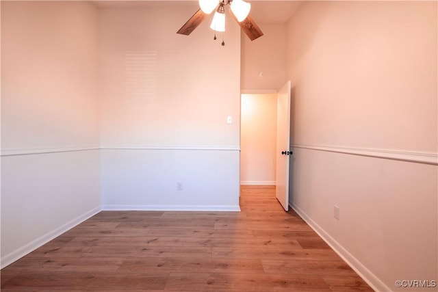 spare room with ceiling fan and light wood-type flooring