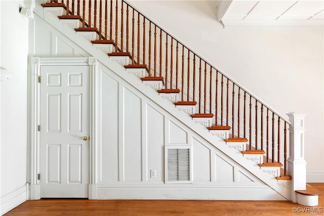 stairway with hardwood / wood-style floors