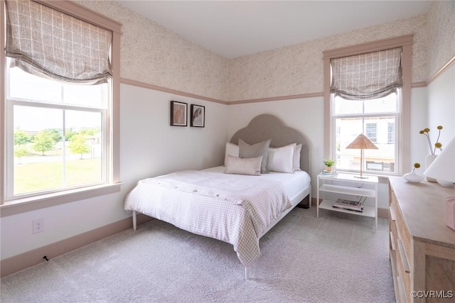 carpeted bedroom featuring multiple windows