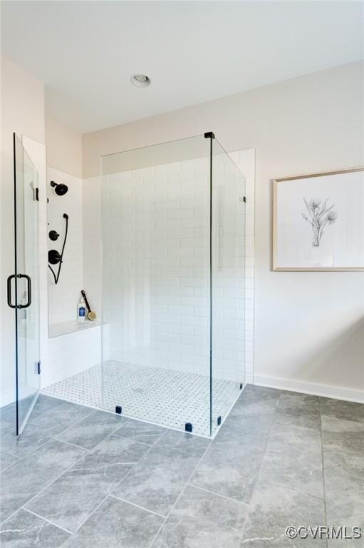 bathroom with a shower with shower door