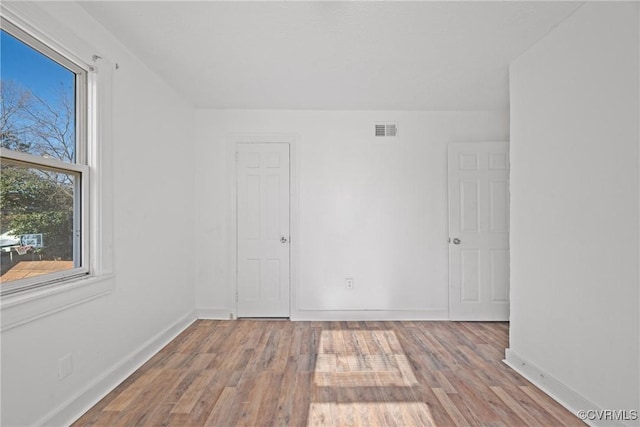 spare room featuring light hardwood / wood-style floors