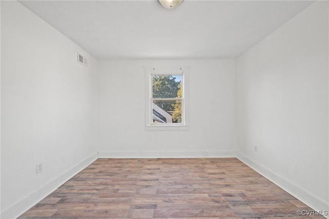 empty room with hardwood / wood-style floors