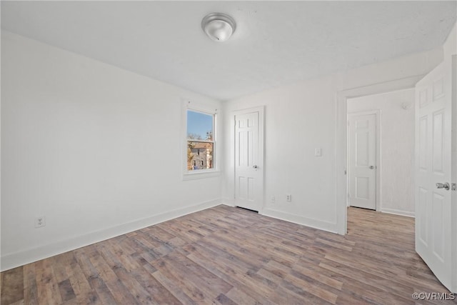 spare room with wood-type flooring