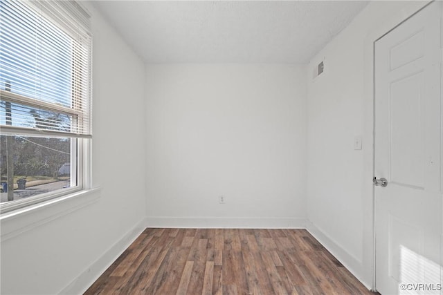 unfurnished room with dark hardwood / wood-style floors