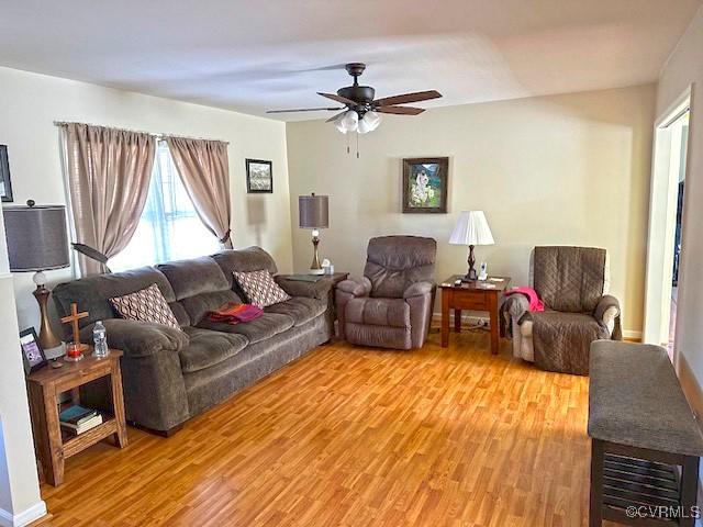 living room with ceiling fan and light hardwood / wood-style floors