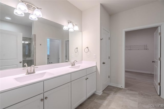 bathroom with vanity and a shower with door