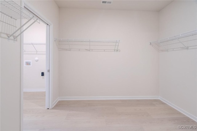 walk in closet featuring light hardwood / wood-style floors