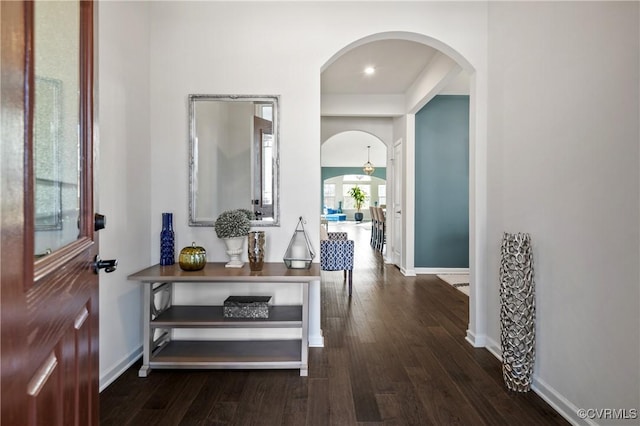 corridor with dark hardwood / wood-style floors