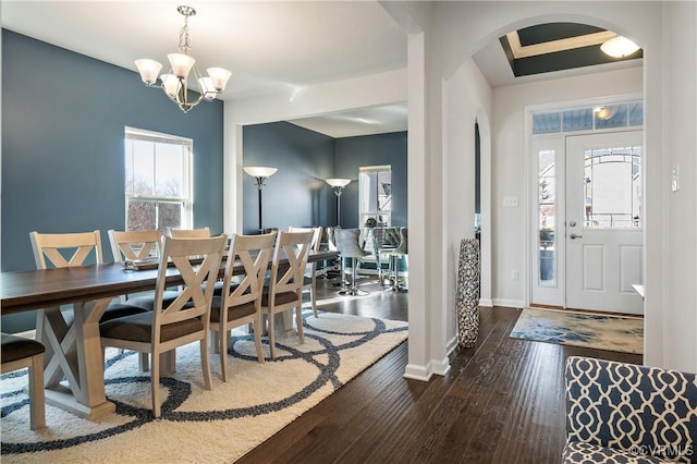 entrance foyer featuring an inviting chandelier and dark hardwood / wood-style flooring