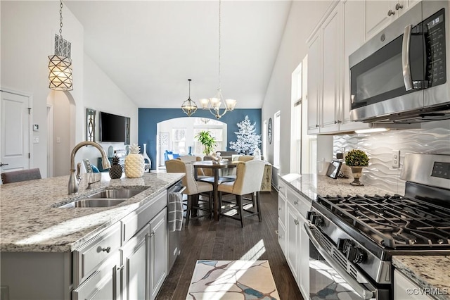 kitchen featuring pendant lighting, white cabinetry, appliances with stainless steel finishes, and sink