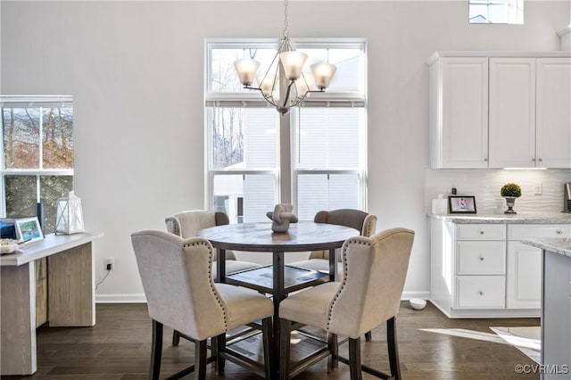 dining area featuring dark hardwood / wood-style floors and a chandelier