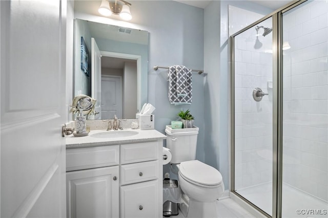 bathroom featuring a shower with door, vanity, and toilet